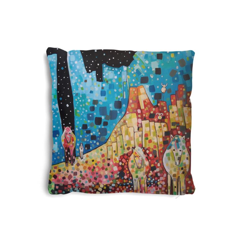 Colorful pillow with artistic design of animals and landcape on a white background