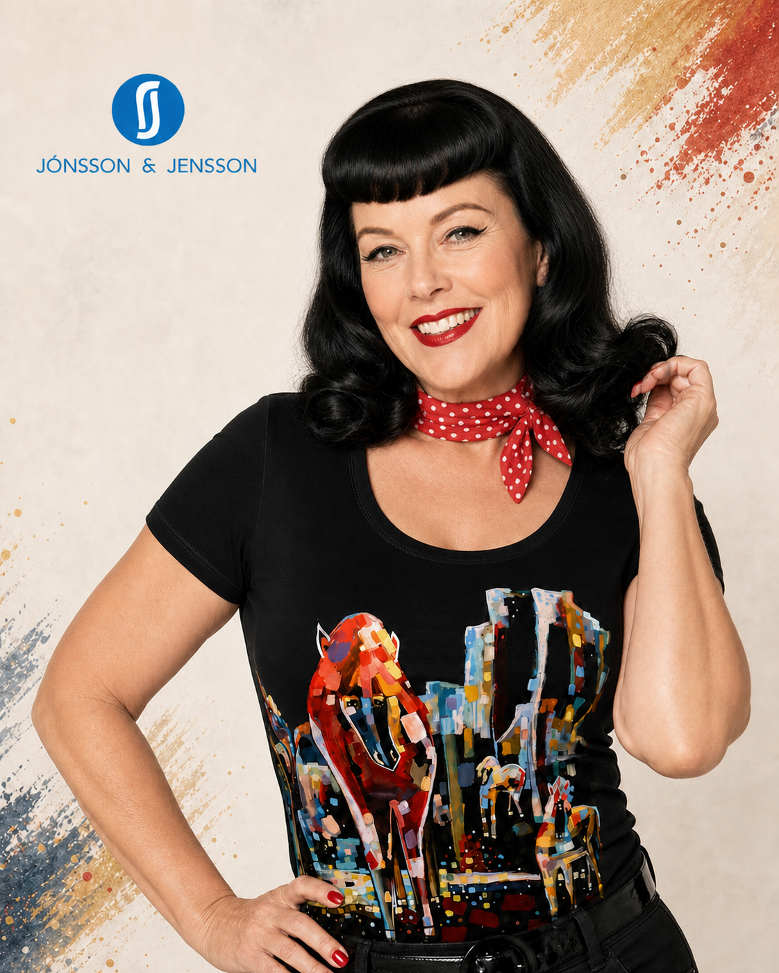 A woman with retro-style black hair and a red polka-dot neck scarf wears a black short-sleeve graphic T-shirt with a colorful cityscape print.