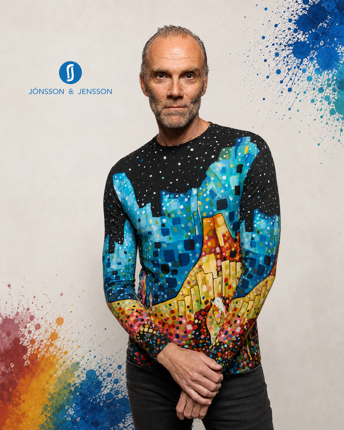 A man wearing a long-sleeve sweater with a vibrant, multicolored mosaic pattern.