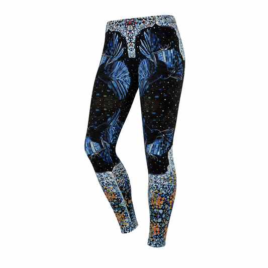 A pair of women's high-waisted leggings with a complex abstract pattern. The upper portion features a black background with blue and white leaf-like motifs and small light dots, while the lower legs transition into dense, colorful speckled patterns in blue, orange, and white.